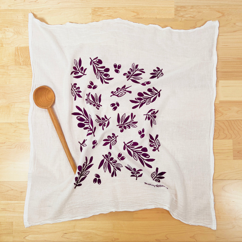 Kei & Molly Olive flour sack dish towel printed in Grape color, front view with spoon prop